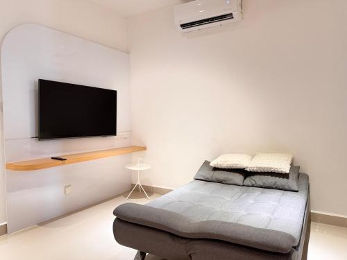 a room with a flat screen tv on a wall at The Shore by New Voyage in Kota Kinabalu