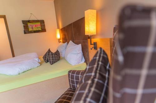 a hotel room with a bed and a couch at Residence Sardis in Castelbello-ciardes