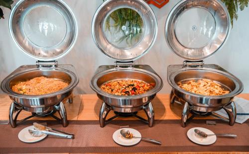 a group of four bowls of food on a table at SureStay by Best Western Iconic Ari-Jatujak in Bangkok