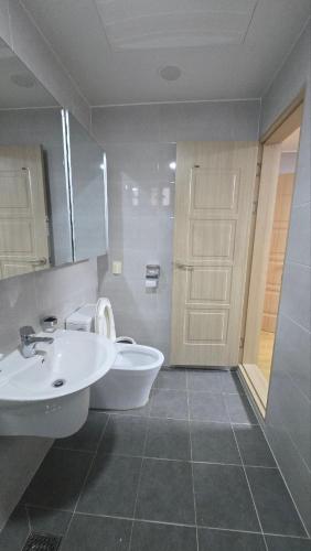 a bathroom with a sink and a toilet and a shower at A-Bridge house 1-A in Incheon