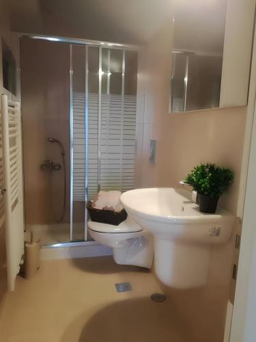 a bathroom with a toilet and a sink and a shower at VISTA DI MARE 3 in Lixouri