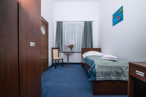 a hotel room with a bed and a desk at Marina Wolin in Wolin