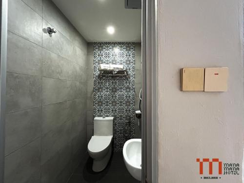 a bathroom with a toilet and a sink at Mana Mana Hotel • Melaka • in Melaka
