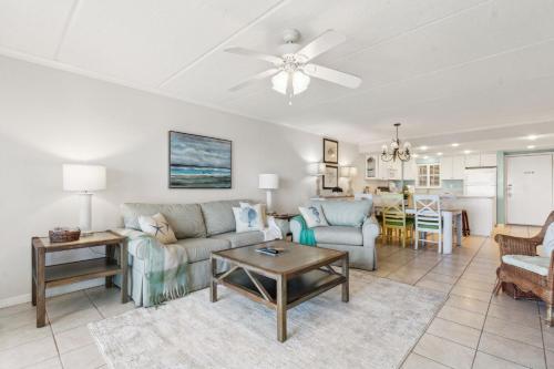 a living room with a couch and a table at Short Walk to the Beach Condo in Fernandina Beach