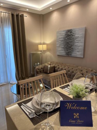 a dining room with a table and a couch at Casa Doro A3 in Larisa