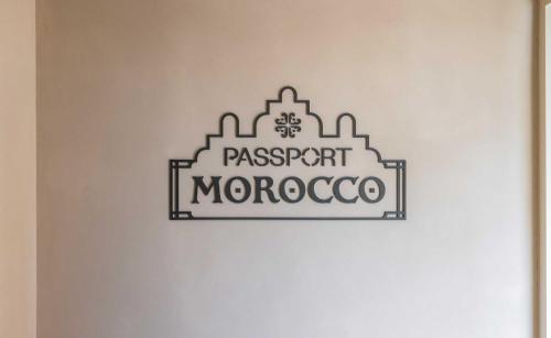 a sign that reads passport morocco on a wall at StayPassport Morocco Spa Incheon Songdo in Incheon