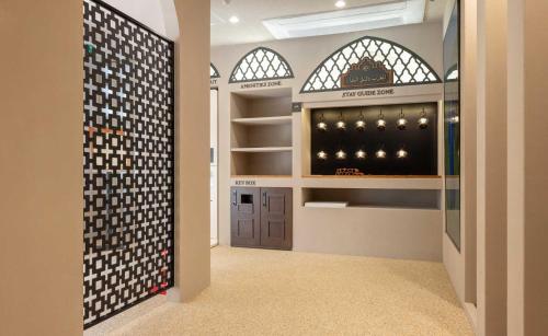 a walk in wine cellar with a wall of wine bottles at StayPassport Morocco Spa Incheon Songdo in Incheon
