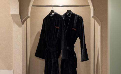 a black robe hanging on a rack in a room at StayPassport Morocco Spa Incheon Songdo in Incheon