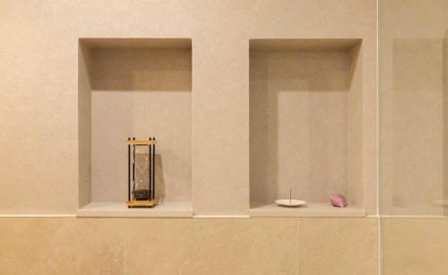 a shelf in a wall with a vase and a candle at StayPassport Morocco Spa Incheon Songdo in Incheon