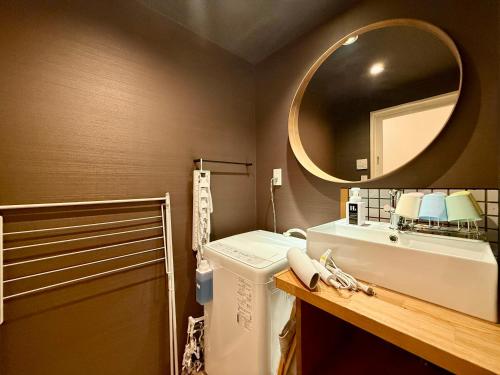 a bathroom with a sink and a mirror at Miyazakiya Kitayama - Hanare - in Kyoto