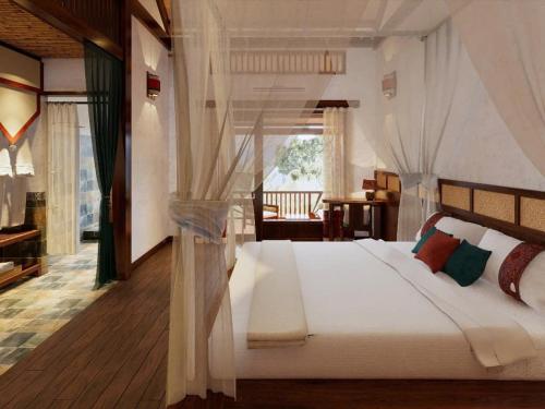 a bedroom with a large white bed in a room at Pù Luông Ecolodge in Pu Luong