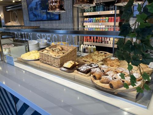 a bakery display case with various pastries and bread at Hotel Nido Príncipe Pío in Madrid