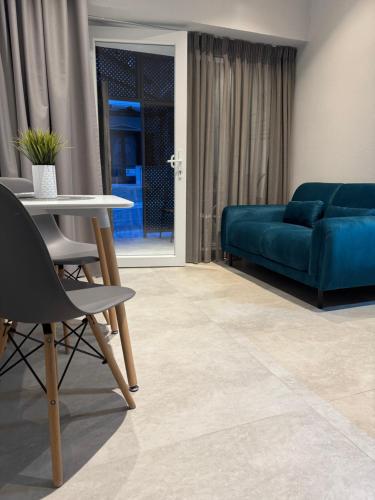 a living room with a couch and a table at Karamelas Vacation House in Nea Kalikratia