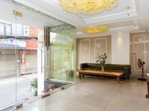 a lobby with a couch and a table in a room at Thái An Hotel Hồ Chí Minh in Ho Chi Minh City