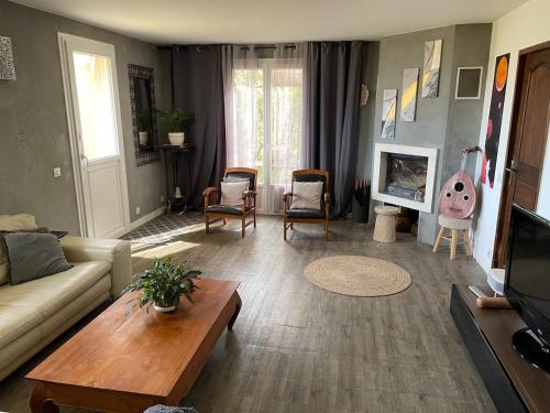 a living room with a couch and a table at Zen house with a view in Manosque