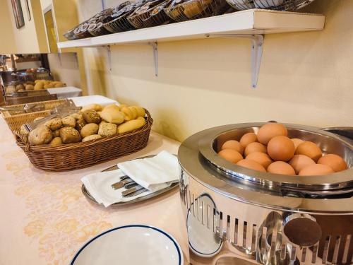 a kitchen with a counter with eggs and baskets of food at Aparthotel Pineda in Bibione