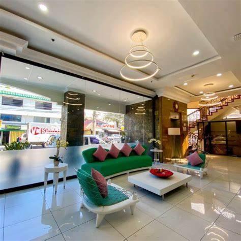 a living room with a green couch in a store at The Inns Bacolod in Bacolod
