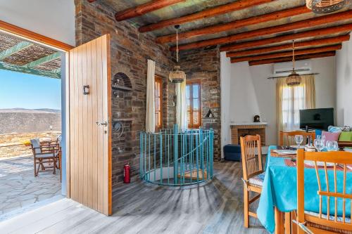 a living room with a table and a dining room at Archontiko Keli in Katákoilos