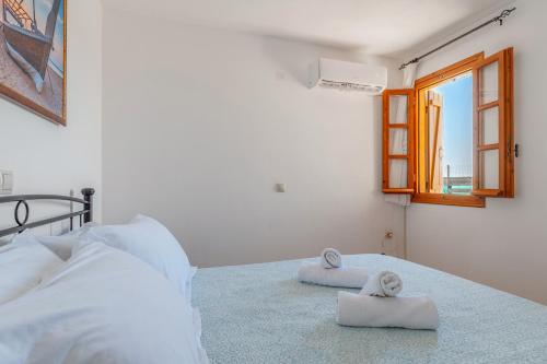 a bedroom with a bed with towels on it at Archontiko Keli in Katákoilos