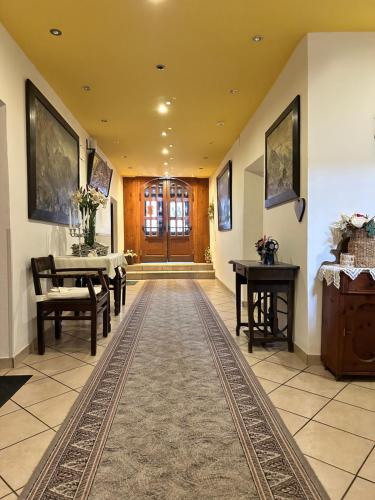 a hallway with a table and a piano in a house at Goldener Adler in Scharnitz