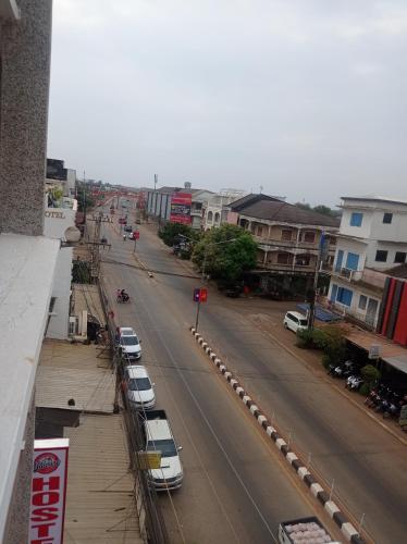 a street with cars parked on the side of a road at Jasmine Hostel & Guesthouse in Pakse