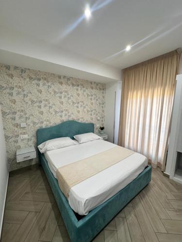 a bedroom with a large bed in a room at Ametista Rooms Tropea in Tropea