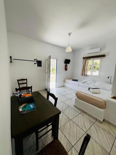 a large living room with a bed and a table at Paradise Apartments Studios in Mylopotas