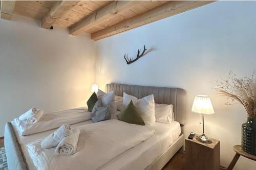 a white bed with towels on it in a room at Monte Vita Tirol - Apartments in Biberwier