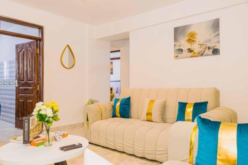 a living room with a couch and a table at Urban 2 bedroom Nanyuki Mt Kenya Views in Nanyuki