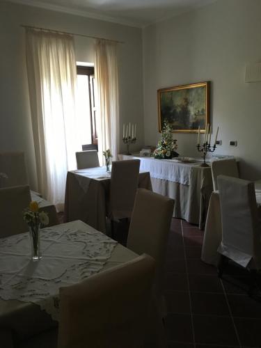 a dining room with tables and chairs and a window at Il Casale di Riardo Luxury B&B in Riardo