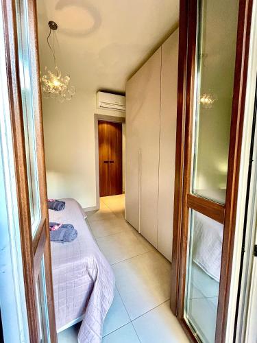 a small room with a bed and a window at Rosso Apartment in Alba