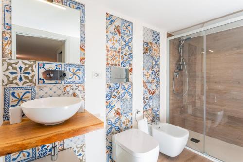 a bathroom with a sink and a shower at Zagara Home - Profumi Di Sicilia in Catania