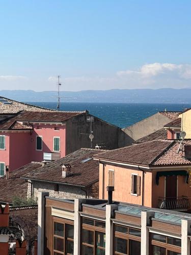 a group of buildings with the ocean in the background at Palazzo Betteloni in Bardolino