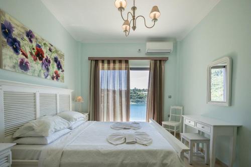 a bedroom with a bed with a desk and a window at White House Apartment in Kalami