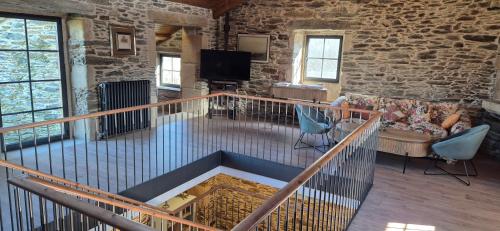 a living room with a stone wall at Casa Escuela Sanguñedo in Magdalena