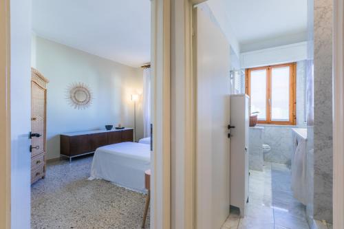 a bedroom with a bed and a bathroom at Italianway - Rossetti 3 in Marina di Cecina