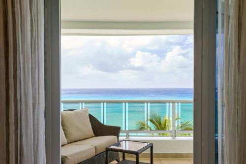 a living room with a view of the ocean at Waves Resort & Spa, Barbados, An Autograph Collection All-Inclusive Resort in Saint James