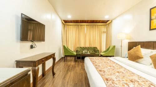 a hotel room with two beds and a desk at Woodrock Luxury Boutique Hotel in Manāli