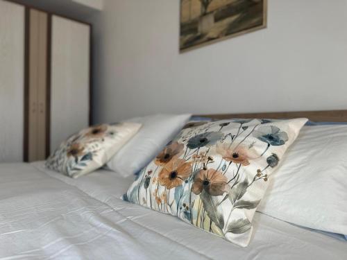 a white bed with two pillows on top of it at Casa di Giggia in Marina di Cerveteri