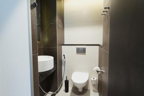 a small bathroom with a toilet and a sink at Home Hotel Jugend in Helsinki
