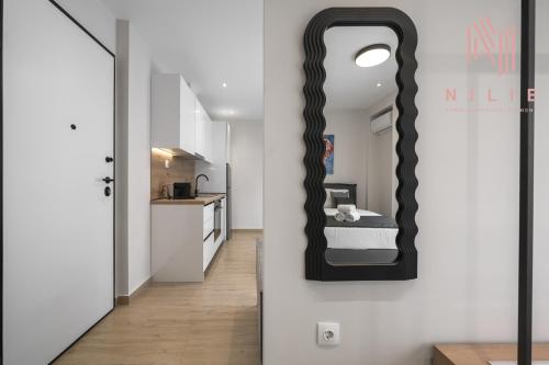 a bathroom with a mirror on the wall at Terra Suites, Nilie Hospitality MGMT in Thessaloniki