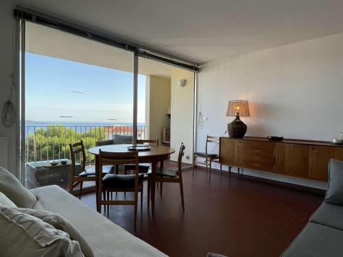 - un salon avec une table et une vue sur l'océan dans l'établissement Appart 2 pièces 2 couchages BANYULS SUR MER BN100-C521, à Banyuls-sur-Mer