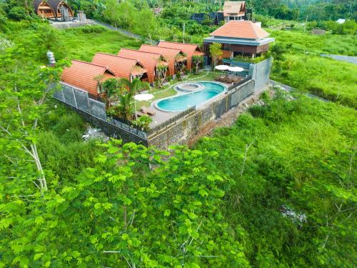 an aerial view of a house with a swimming pool at Lumbung River Ubud Villas in Blahbatu