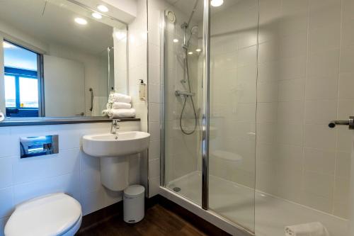 a bathroom with a shower and a toilet and a sink at Travelodge Barcelona Poblenou in Barcelona
