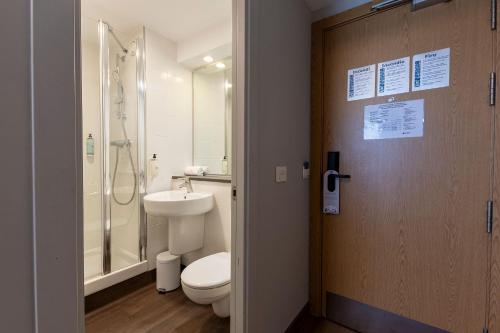 a bathroom with a toilet and a shower and a sink at Travelodge Barcelona Poblenou in Barcelona