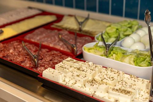 a buffet with meat and cheese and other food at Travelodge Barcelona Poblenou in Barcelona