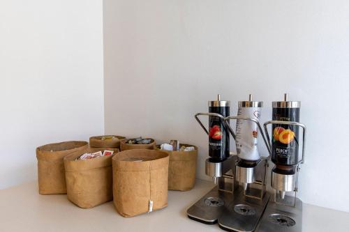 a kitchen counter with a group of containers and a blender at Travelodge Barcelona Poblenou in Barcelona