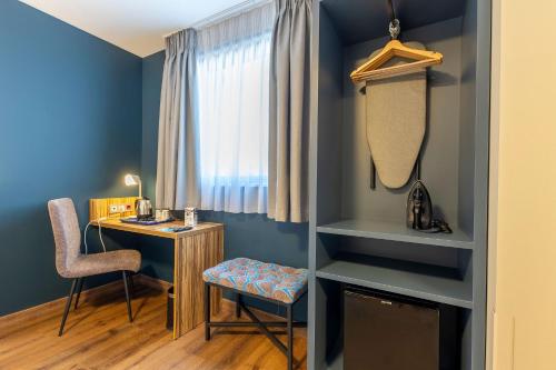 a room with a desk and a chair and a window at Travelodge Barcelona Poblenou in Barcelona