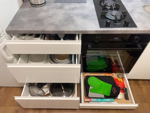 a kitchen island with white drawers and a counter top at IG Apartments in Karmėlava
