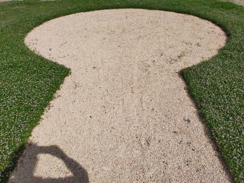 a shadow of a person walking on a sidewalk at Mas de charme au pied des Alpilles in Maussane-les-Alpilles